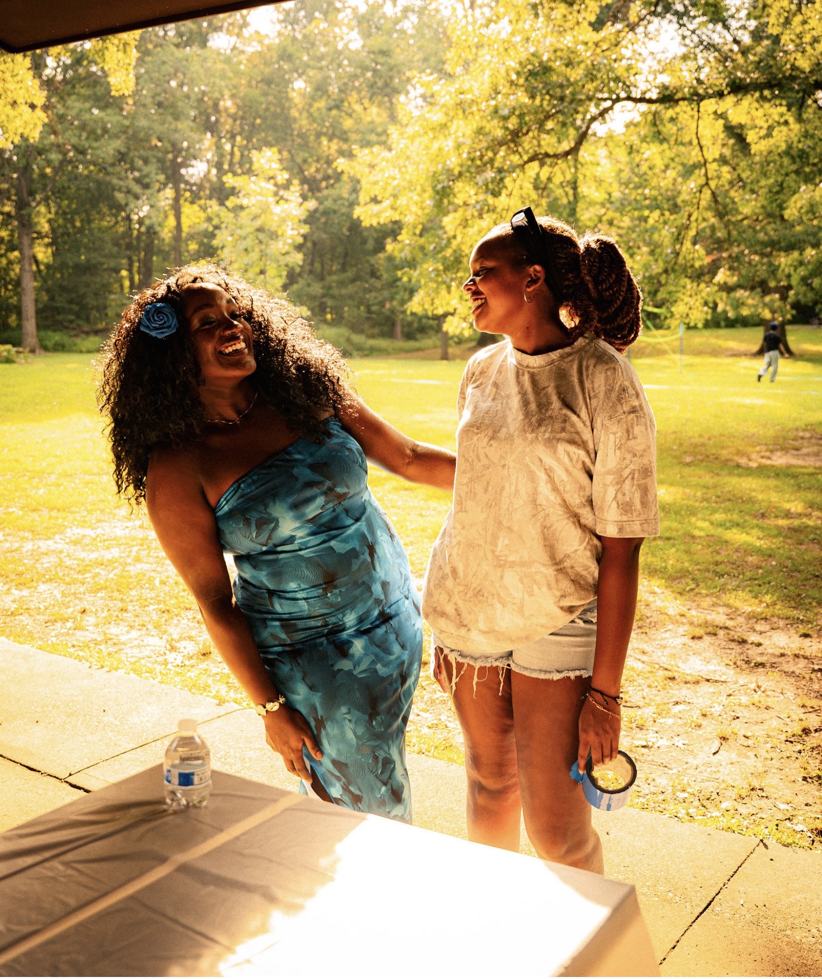 Two friends laugh together in the summer sun