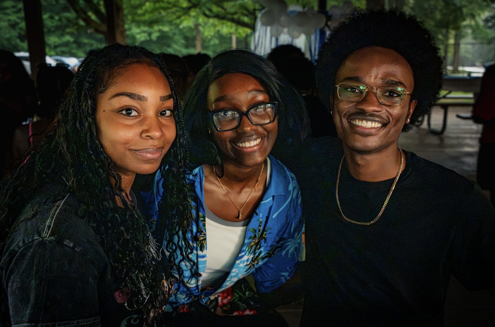 Three friends smile for a close-up